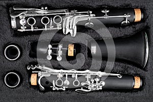 Black clarinet  silver wooden woodwind musical brass instrument in pieces parts music case. classic orchestra symphony background
