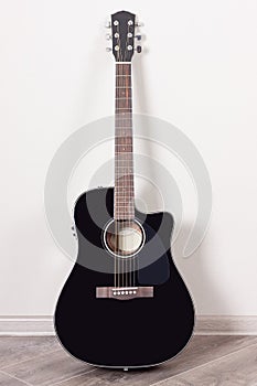 Black Classical Acoustic Guitar in an Empty Room