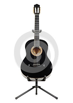 Black classical guitar on a guitar stand