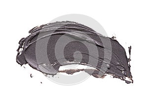 Black clay facial mask smear on white isolated background