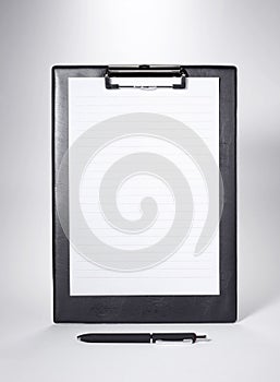 Black Clip board with blank paper and a pen