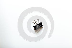 A Black clip on white surface