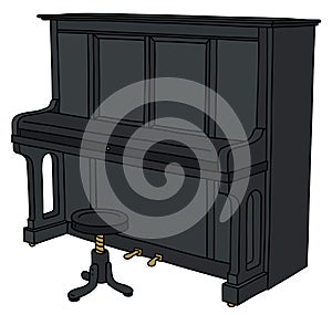 The black closed pianino with a chair