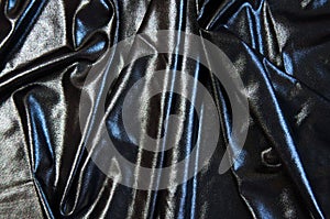 Black cloth waves abstract textile background. Fabric as pitch oil. Dark wallpaper.