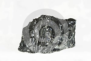 Black coal mine close-up with large depth of field. Anthracite coal bar isolated on white background