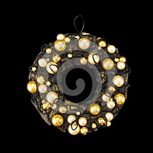 Black coal ring decorated with shoelaces and gold balls as an element of the interior on a black background