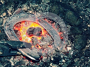 Black coal stove of blacksmith heating classic horseshoe photo