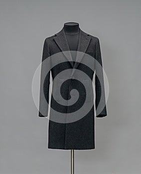 Black coat on a mannequin in the studio