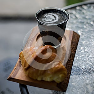 Black coffe and croisant photo