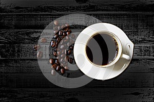 Black coffee in the cup on wood dark table with copy space photo