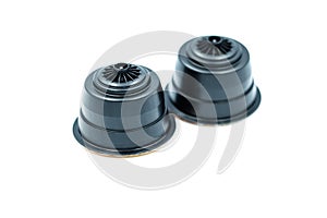 Black coffee capsules for an automatic coffee machine isolated on white.