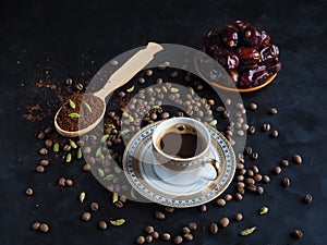 Black coffee with cardamom and dates. Traditional Arabic coffee.