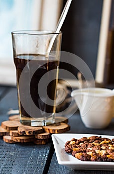 Black coffee cup with biscuits and chocolate