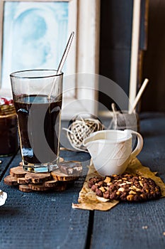 Black coffee cup with biscuits and chocolate
