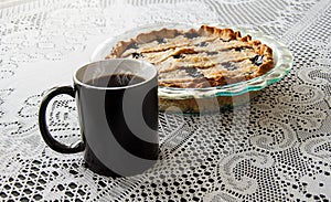 Black coffee cup and blueberry pie
