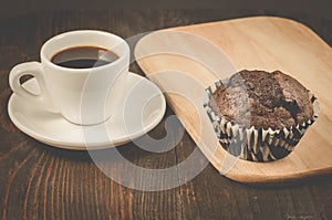 black coffee cup, chocolate muffin and wooden tray/black coffee cup, chocolate muffin and wooden tray, selective focus