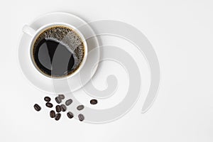 Black coffee in a cup and coffee beans isolated on a white background