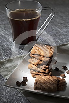 Black coffee cup with cookies and coffee bens