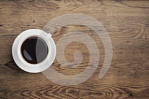 Black coffee cup on old wooden table top view