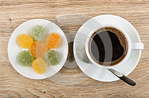 Black coffee in cup, spoon and marmalade in saucer