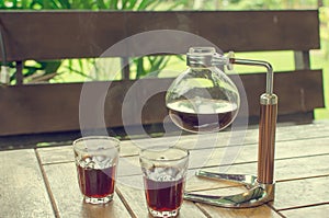 Black coffee in glass and coffee jar