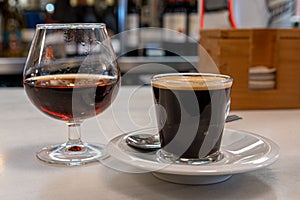 Black coffee with a glass of cognac for after-dinner drinks