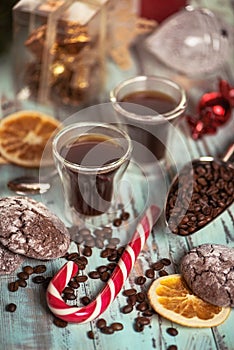 Black coffee in glass cups with christmas decoration with cookies and candies