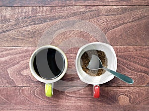 black coffee and instant coffee with silver spoon in cup on desk floor with copy space