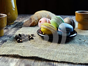 Black coffee and macarone on black background