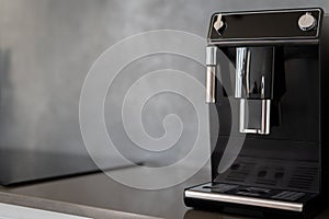 Black coffee making machine on shiny kitchen counter