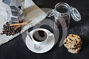 Black coffee with moka pot and cookies.