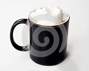 Black coffee mug with frothed milk mockup