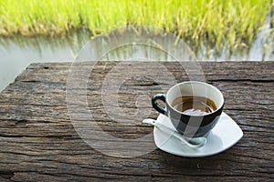 Black coffee mug on wooden floor