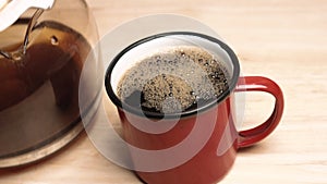 Black Coffee Pouring Into A Cup