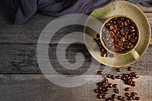 Black coffee seed for morning menu in brown ceramic cup with coffee beans roasted