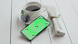 Black coffee with smart phone, on white rustic wooden table