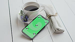 Black coffee with smart phone, on white rustic wooden table