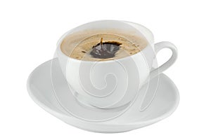 Black coffee in a white china cup, speaker, coffee splash on a white background