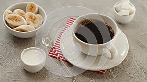 Black coffee in white cup on concrete texture table. Breakfast coffee cup