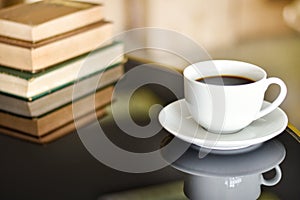 Black coffee in white cup on glass table