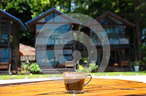 Black coffee on the wooden table, beachside, travel concept , nature light. Thailand