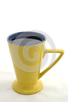 Black coffee in yellow triangular cup