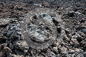 Black cold lava textured background in Lanzarote, Canary Islands Spain