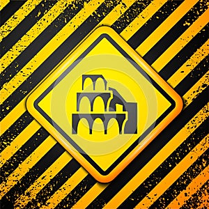 Black Coliseum in Rome, Italy icon isolated on yellow background. Colosseum sign. Symbol of Ancient Rome, gladiator