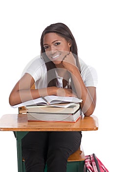 Black college student woman with book by desk
