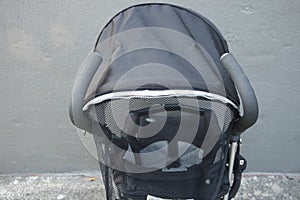 Black color baby stroller with head covering photo