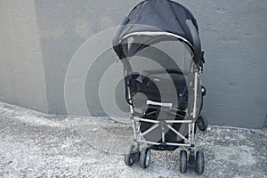 Black color baby stroller with head covering photo