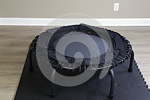 Black Color Bungee Rebounder Exercise Device On A Black Mat