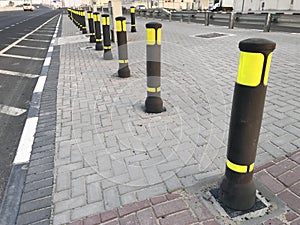 Black color with yellow fluorescent warning safety reflector poles fixed over roadside interlocks