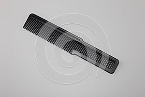 The black comb of the barber Placed on a gray background